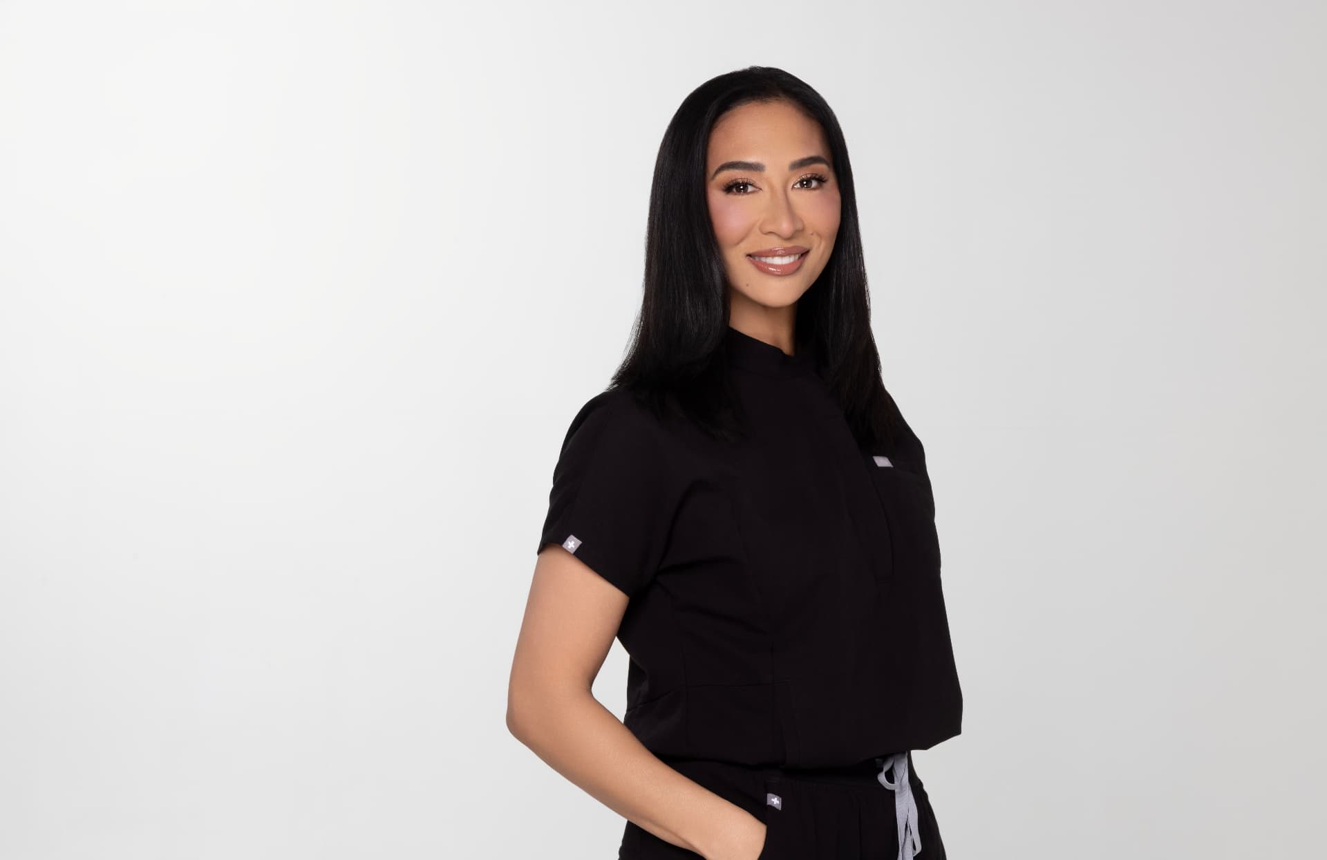 Dr. Sheena Kawamoto in black scrubs
